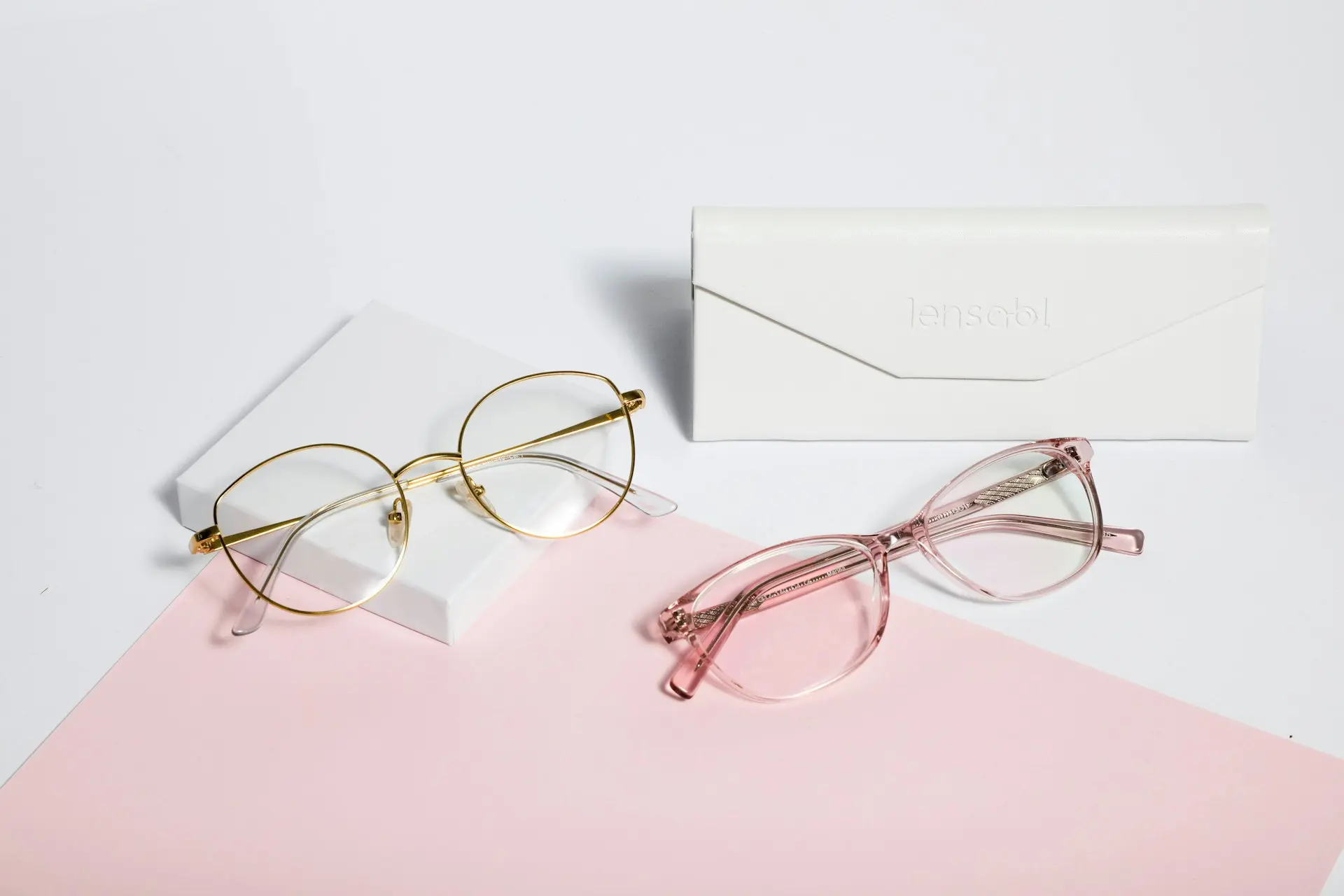 gold framed eyeglasses on white paper
